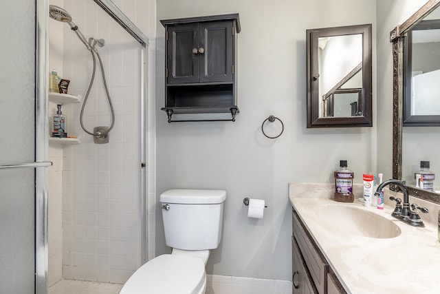 bathroom with vanity, a shower with shower door, and toilet