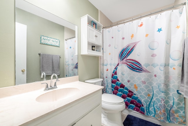 bathroom with tile patterned flooring, vanity, and toilet