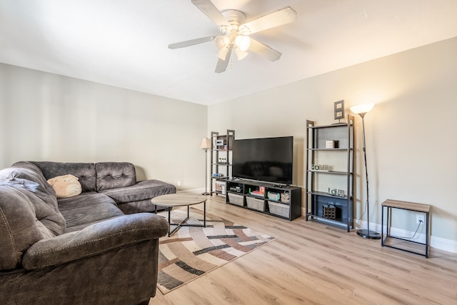 living room featuring ceiling fan and light hardwood / wood-style floors