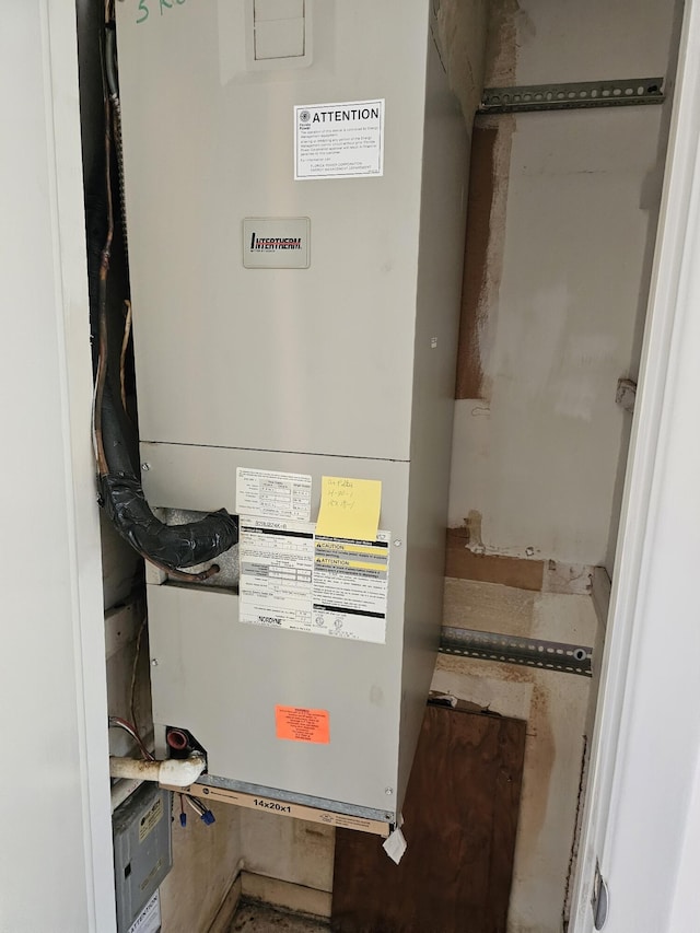 utility room featuring heating unit