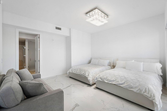 bedroom featuring a notable chandelier