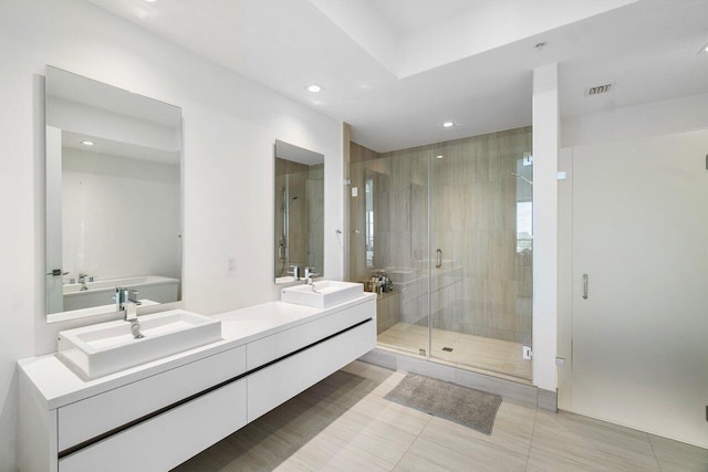 bathroom featuring tile patterned flooring, vanity, and separate shower and tub