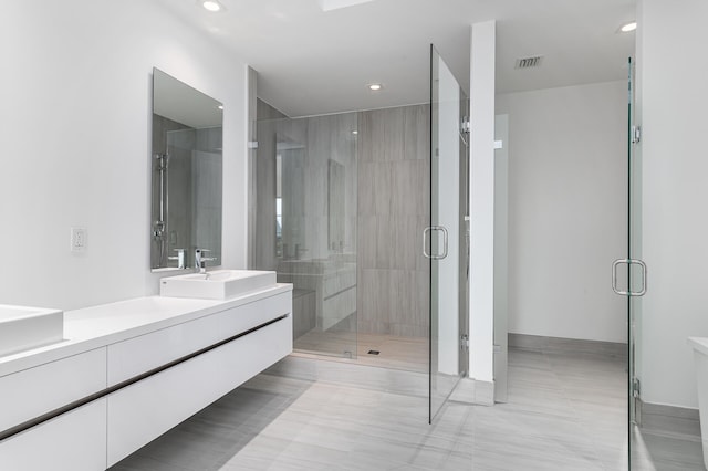 bathroom featuring vanity and a shower with shower door