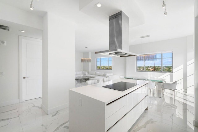 kitchen featuring white cabinetry, black electric stovetop, a center island, and island range hood