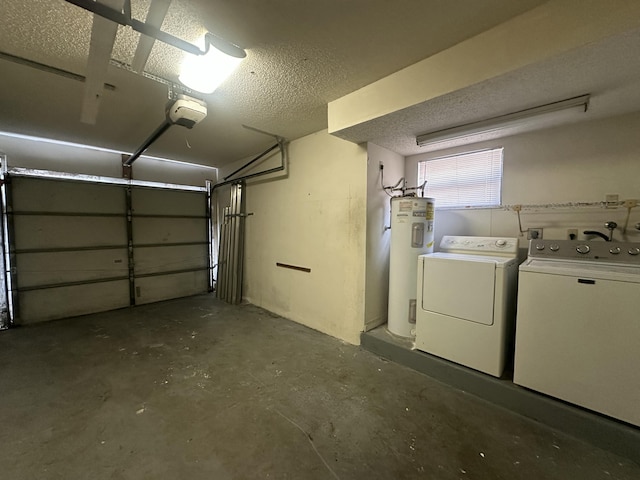 garage featuring electric water heater and washing machine and clothes dryer