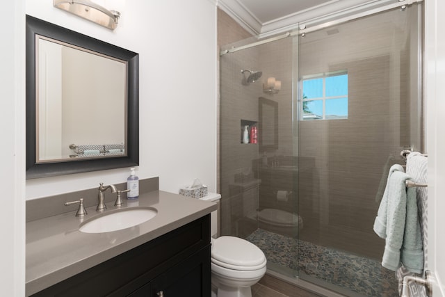 full bath featuring crown molding, a shower stall, toilet, and vanity