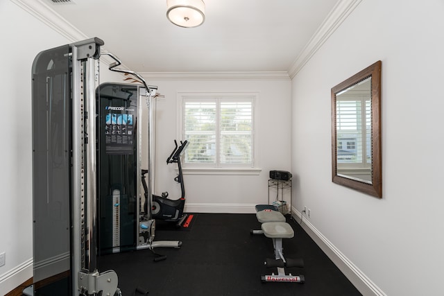 workout room featuring ornamental molding and baseboards