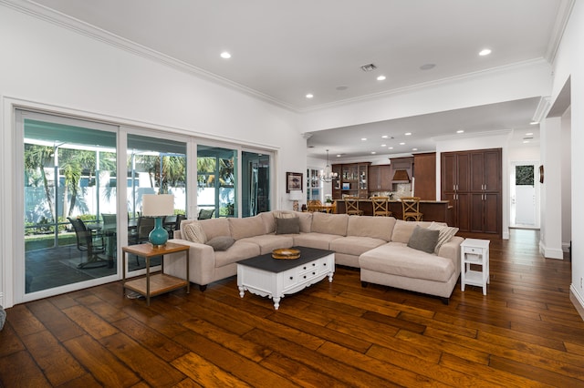 living room with dark wood-style floors, crown molding, and recessed lighting