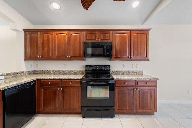 kitchen featuring light stone counters, light tile patterned floors, and black appliances