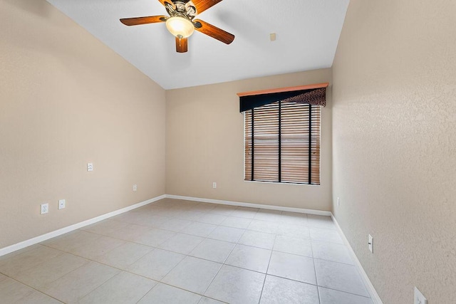 tiled empty room featuring ceiling fan and lofted ceiling