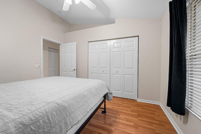 bedroom featuring a closet, ceiling fan, hardwood / wood-style floors, and vaulted ceiling