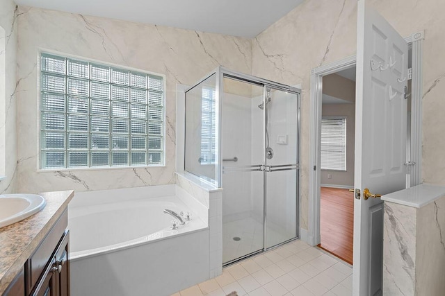 bathroom featuring separate shower and tub, vanity, a healthy amount of sunlight, and hardwood / wood-style flooring