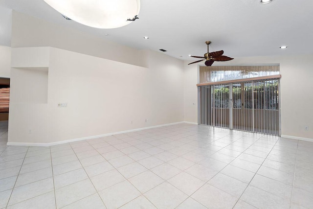 tiled empty room featuring ceiling fan