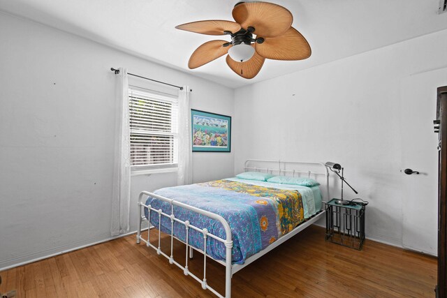 bedroom featuring dark hardwood / wood-style floors and ceiling fan