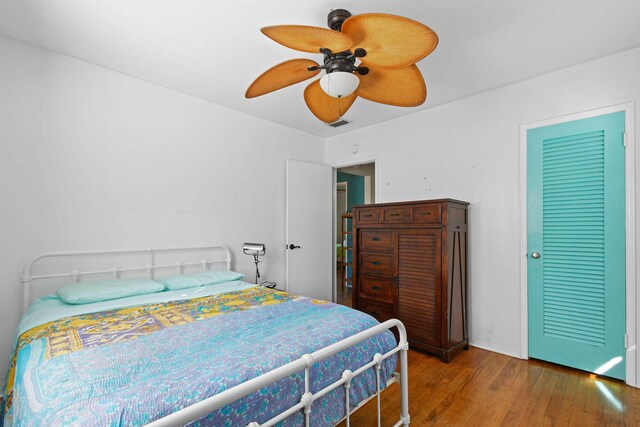 bedroom with hardwood / wood-style flooring and ceiling fan