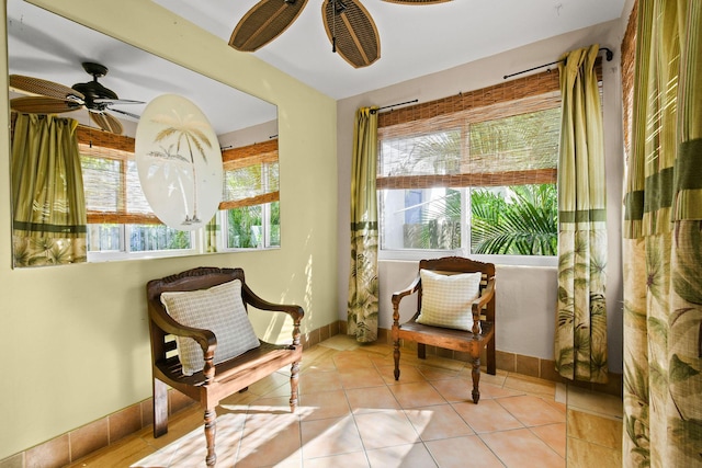 sitting room with ceiling fan and light tile patterned flooring