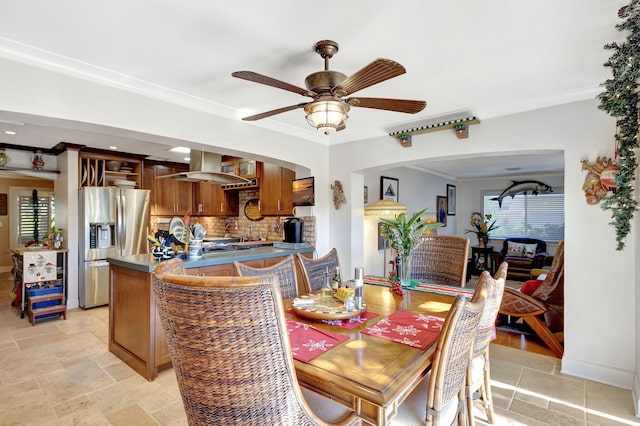 dining area featuring ceiling fan, plenty of natural light, and ornamental molding