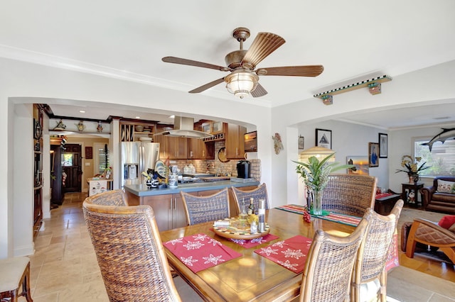 dining area featuring ceiling fan and crown molding