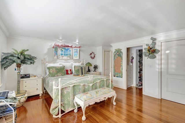 bedroom featuring crown molding, a closet, and hardwood / wood-style flooring