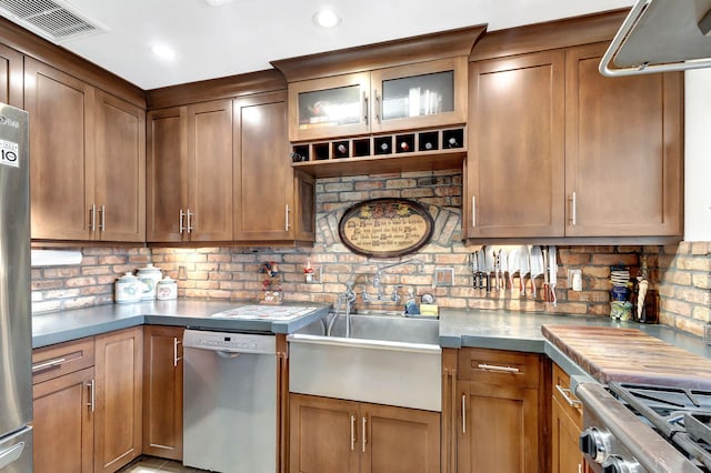 kitchen featuring stainless steel appliances, tasteful backsplash, and sink