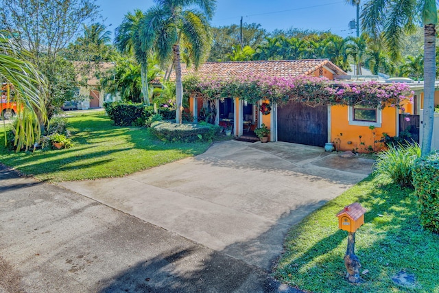 view of front facade with a garage and a front lawn