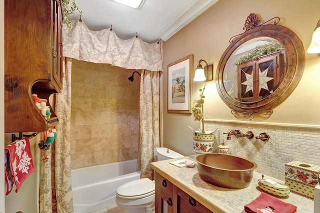 full bathroom featuring vanity, toilet, shower / bathtub combination with curtain, ornamental molding, and tile walls