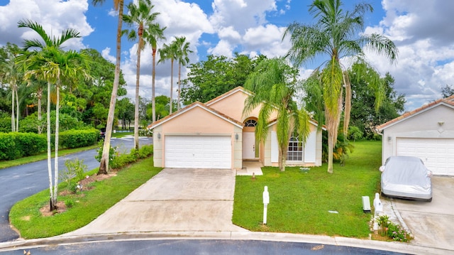 view of front facade with a garage and a front lawn