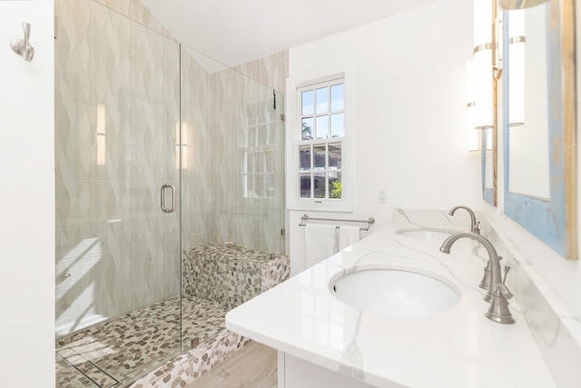 bathroom featuring hardwood / wood-style floors, vanity, and a shower with shower door