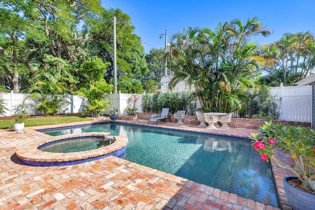 view of pool with an in ground hot tub and a patio