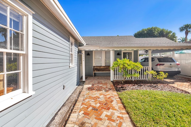 doorway to property with a carport