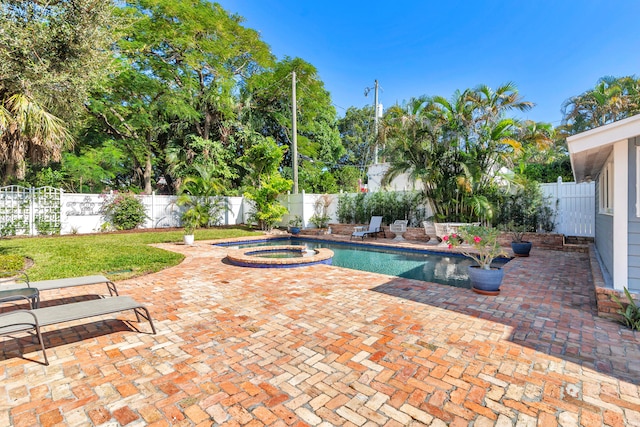 view of pool with a patio area and an in ground hot tub