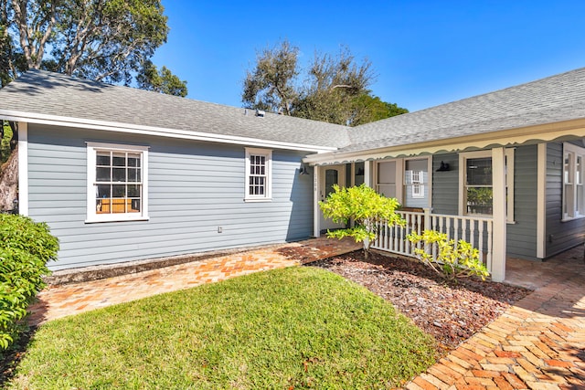 view of front of property with covered porch and a front yard