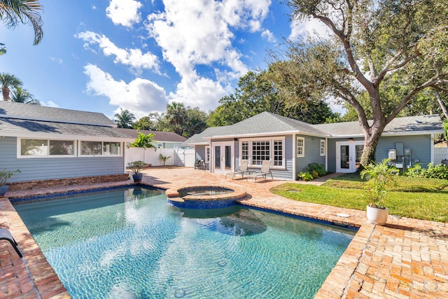 view of pool with an in ground hot tub, french doors, and a patio