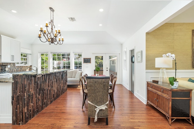 dining area featuring dark hardwood / wood-style floors, french doors, a healthy amount of sunlight, and lofted ceiling