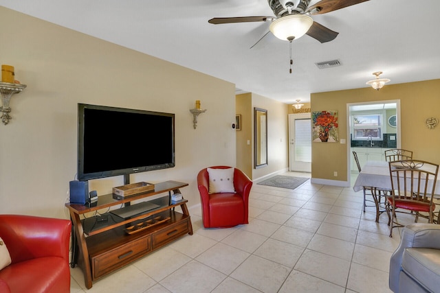 living room with ceiling fan and light tile patterned floors