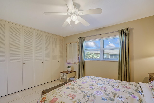 tiled bedroom featuring ceiling fan and a closet