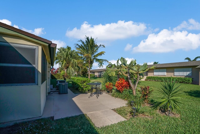 view of yard featuring a patio and central AC unit