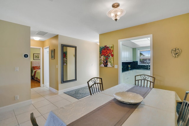 dining room featuring sink and light tile patterned flooring