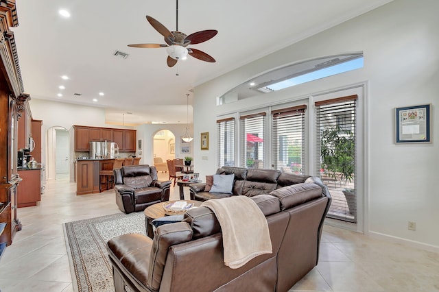 tiled living room featuring ceiling fan and lofted ceiling