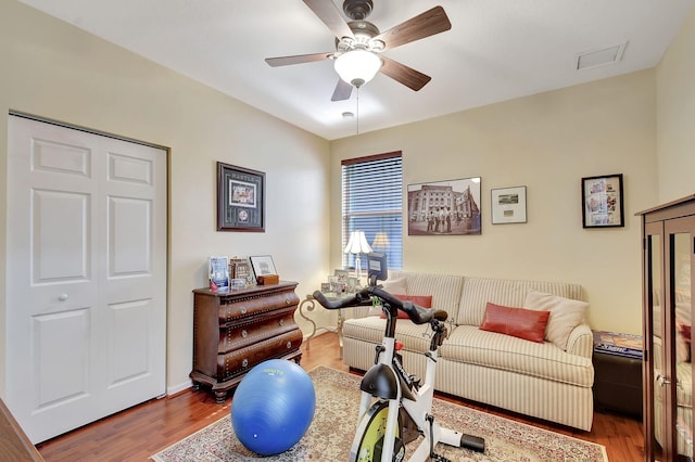 living room featuring hardwood / wood-style floors and ceiling fan