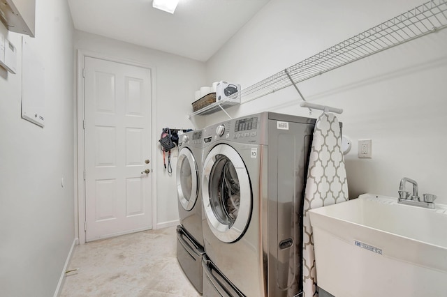 laundry room featuring washer and clothes dryer and sink