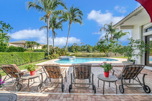 view of swimming pool featuring an in ground hot tub and a patio