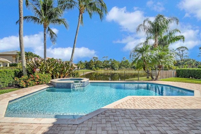 view of pool featuring an in ground hot tub, a water view, and a patio