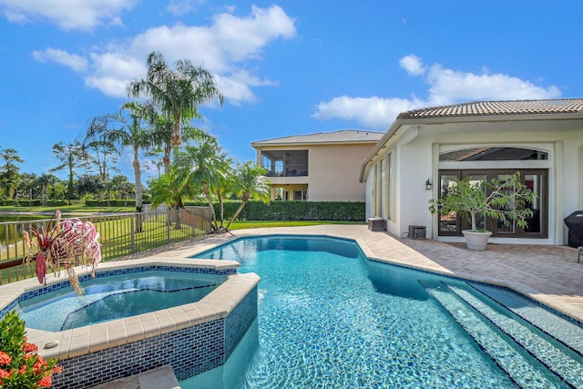 view of swimming pool with a patio area and an in ground hot tub