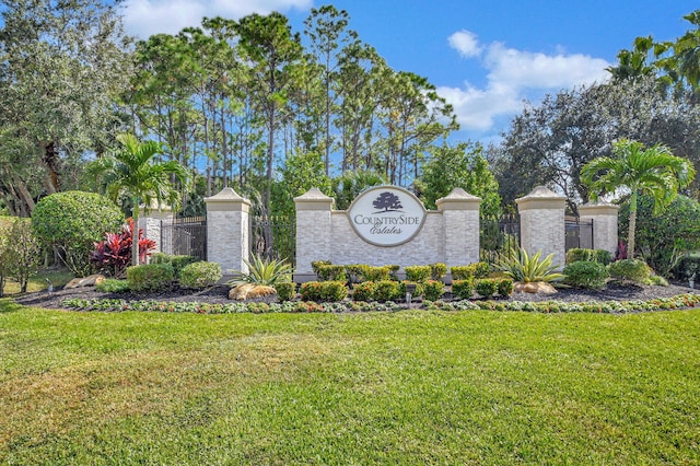 community / neighborhood sign with a yard