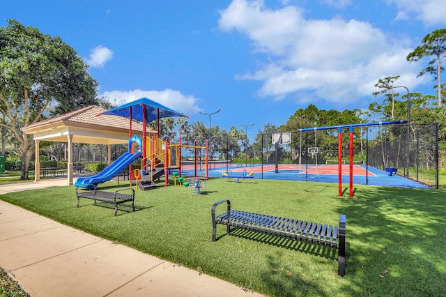 view of play area with tennis court, basketball court, and a yard