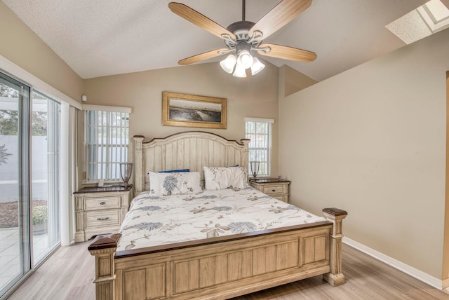 bedroom with ceiling fan, multiple windows, access to outside, and vaulted ceiling