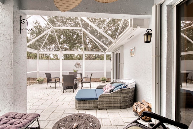 view of patio featuring a lanai