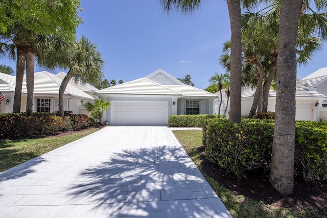 3 Blenheim Ct, Palm Beach Gardens, FL 33418 - ranch-style house with a garage, decorative driveway, and stucco siding