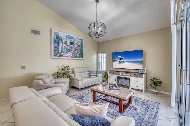 living room featuring light tile patterned floors, a chandelier, vaulted ceiling, a textured ceiling, and baseboards